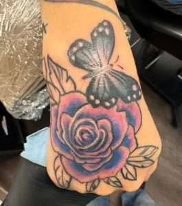 Butterfly and rose hand tattoo in full colour, tattooed at Nu Nebula Tattoo