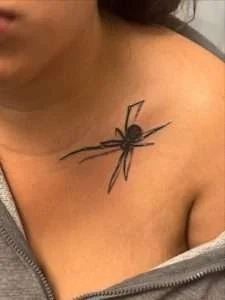 Spider chest tattoo in fine-line black and grey, tattooed at Nu Nebula Tattoo