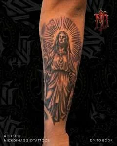 Virgin Mary calf tattoo in black and grey realism, tattooed by Nick DiMaggio