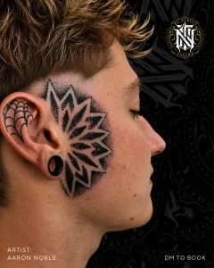 Mandala tattoo on the side of the head in black and grey, tattooed by Aaron Noble