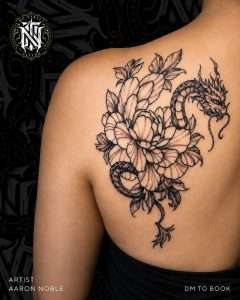Peony and dragon across the shoulder in fine line, tattooed by Aaron Noble