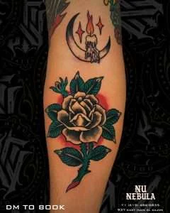 Rose and candle calf tattoo in neo-traditional colour, tattooed by Aaron Noble
